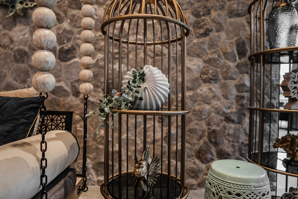 a birdcage filled with a bunch of items next to a couch