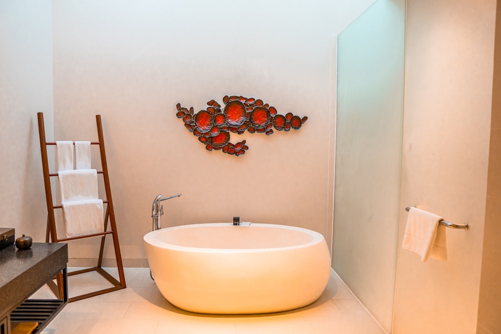 a bathroom with a round sink and a ladder