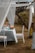 A beautifully set dining table outdoors, surrounded by lush greenery and soft lighting.
