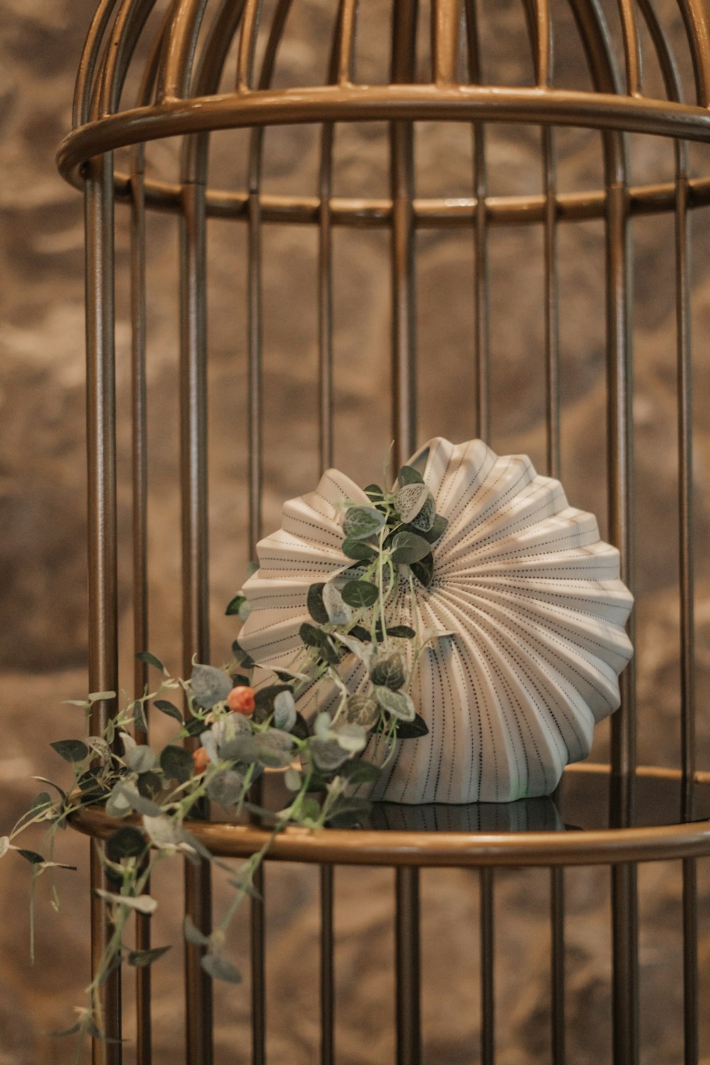 a white fan sitting on top of a table next to a birdcage