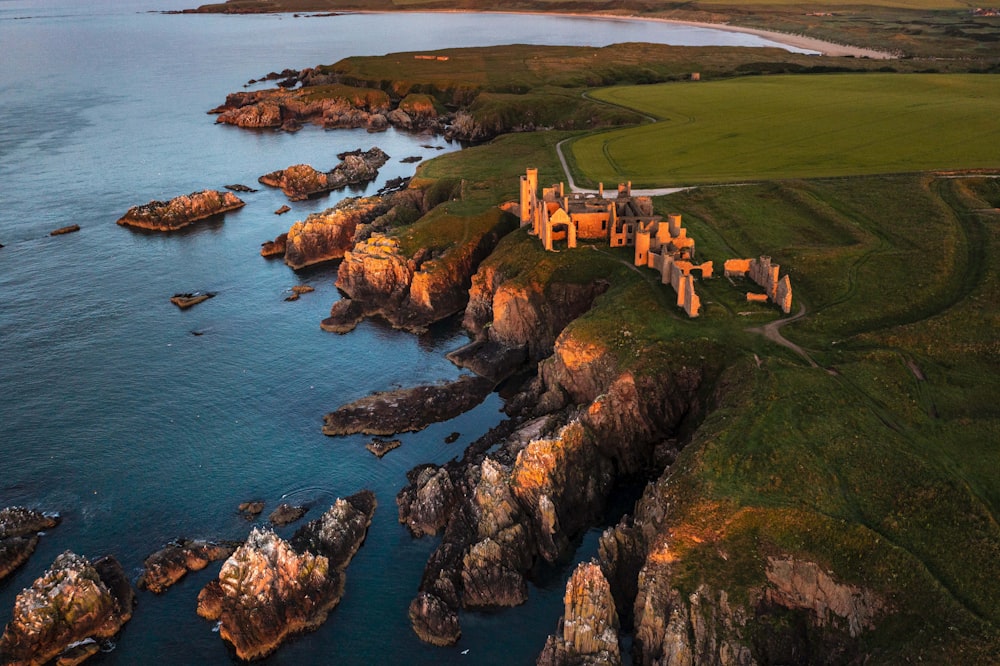 an aerial view of a castle in the middle of a body of water