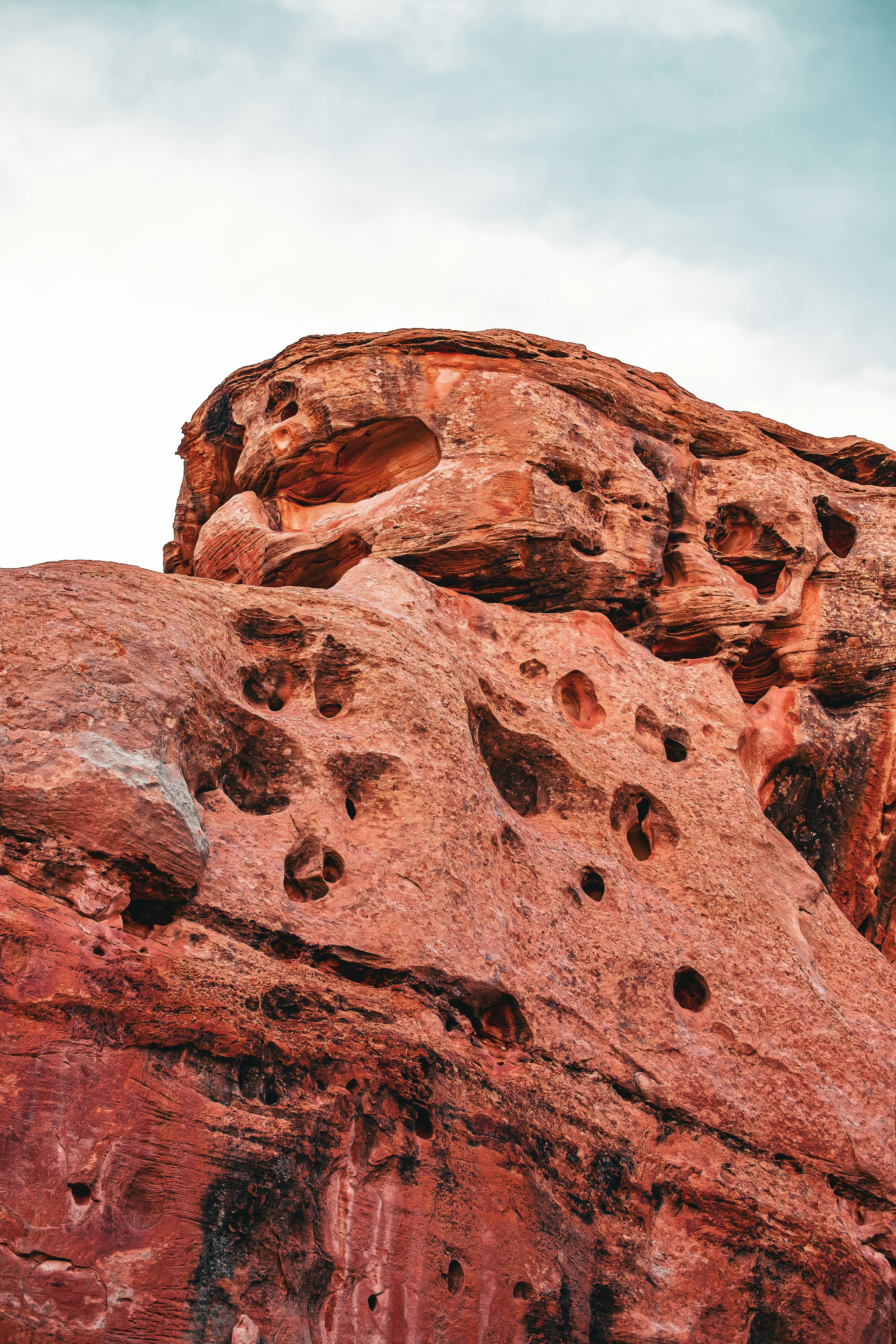 a rock formation with holes in the middle of it