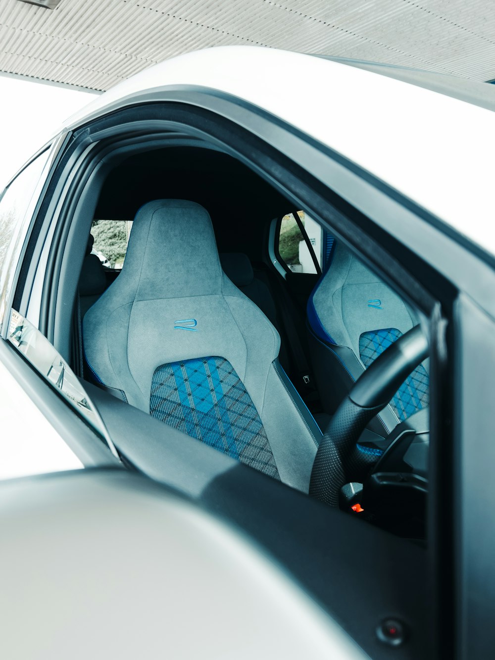 the interior of a car with blue seats