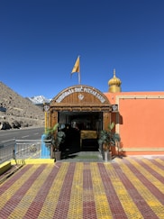the entrance to a building with a flag on top of it