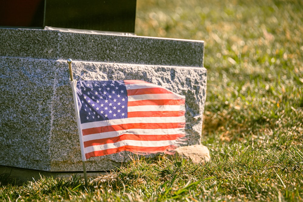 an american flag is placed on a grave
