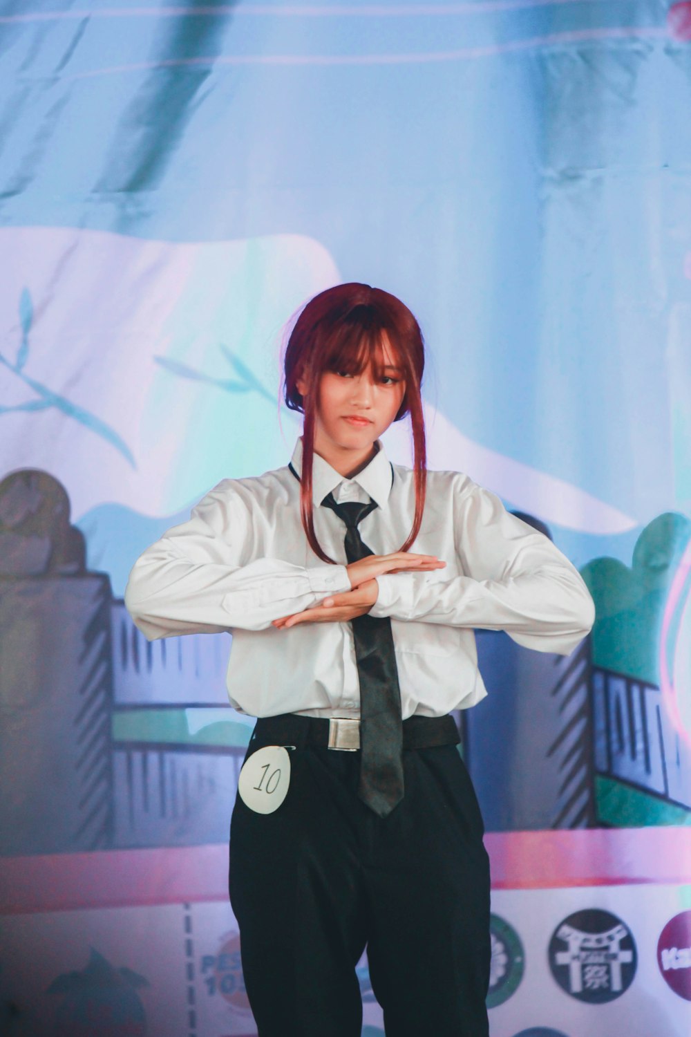 a man with red hair wearing a white shirt and black tie