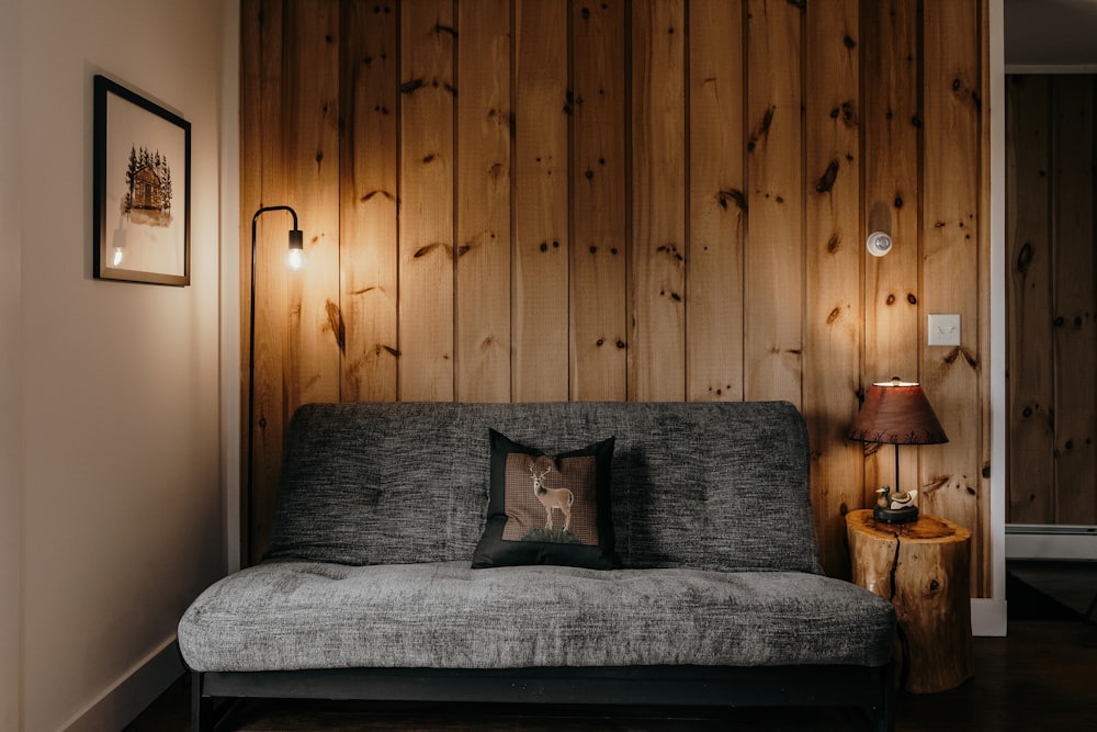 a living room with wood paneling and a couch