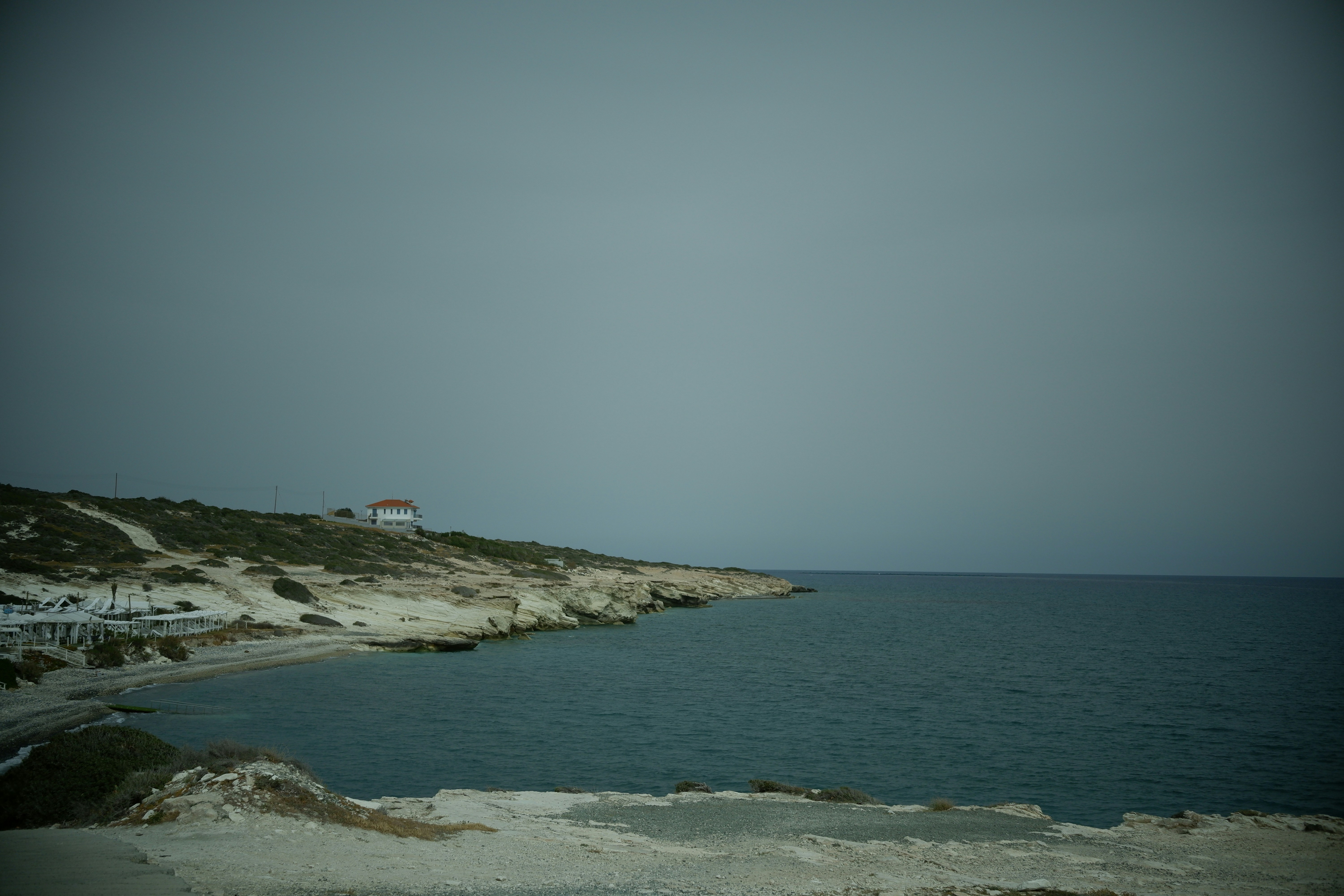 a house on a hill overlooking a body of water