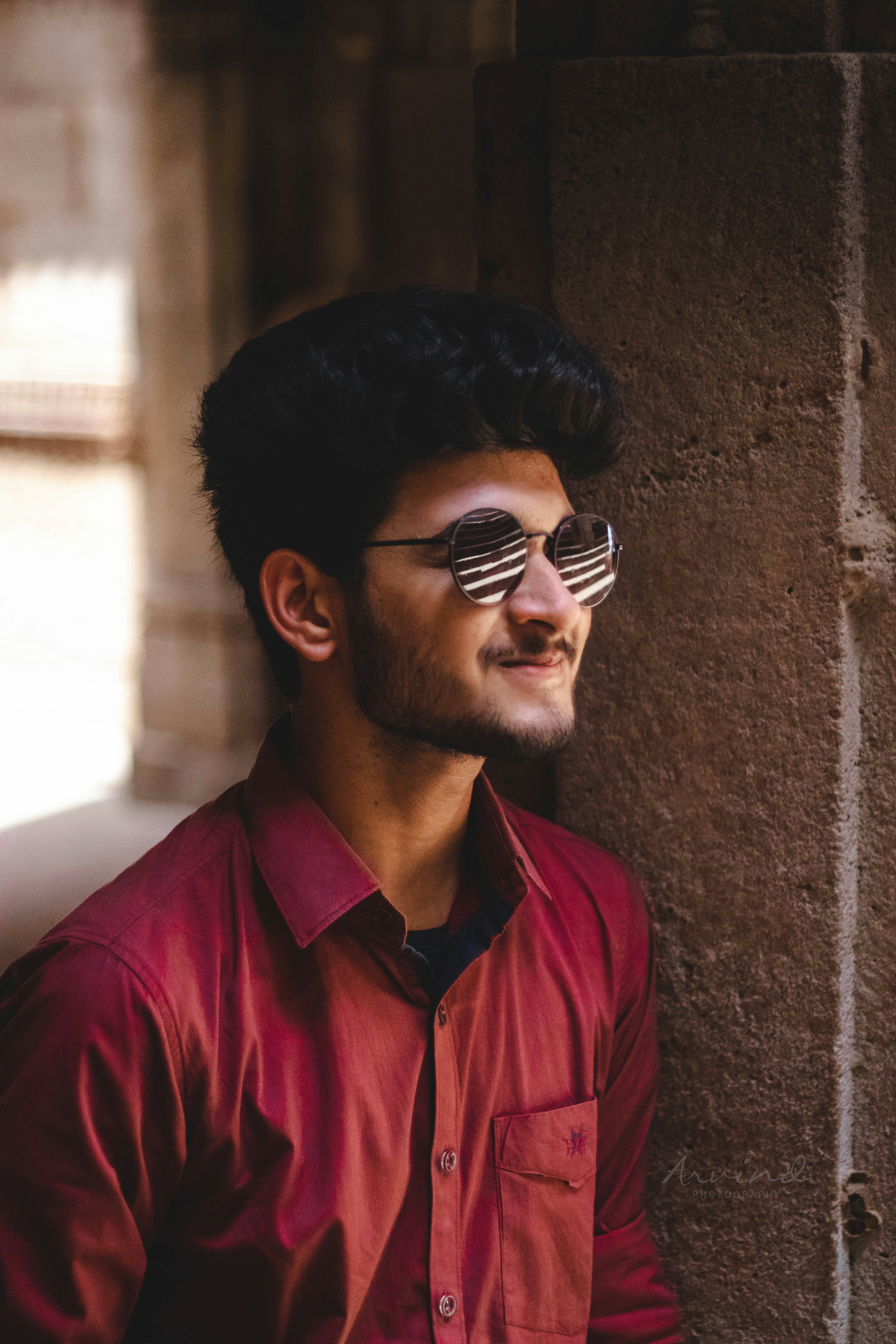 a man wearing sunglasses and a red shirt