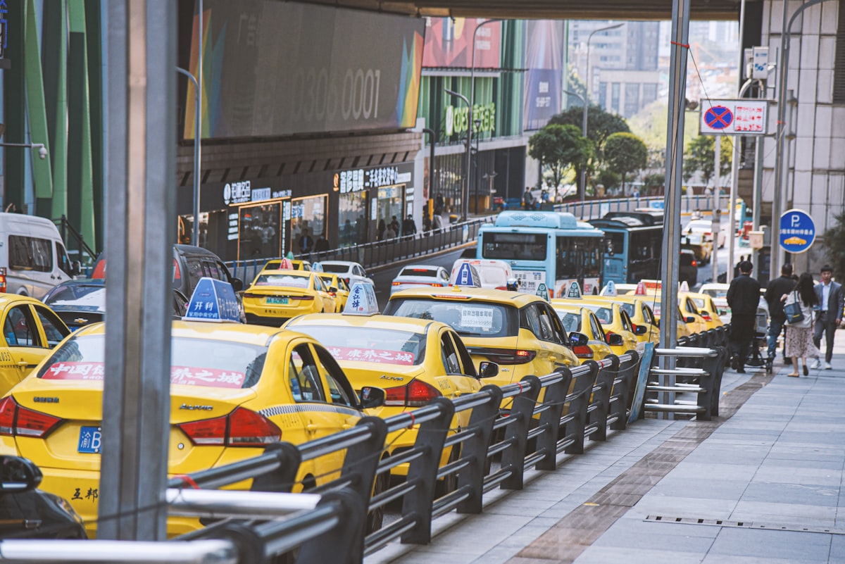 A busy city street filled with yellow taxi cabs and traffic