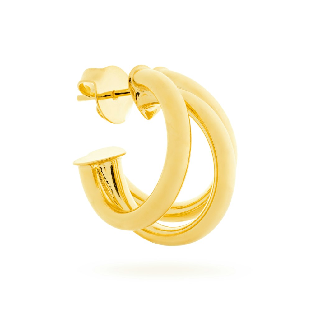 a pair of gold hoop earrings on a white background