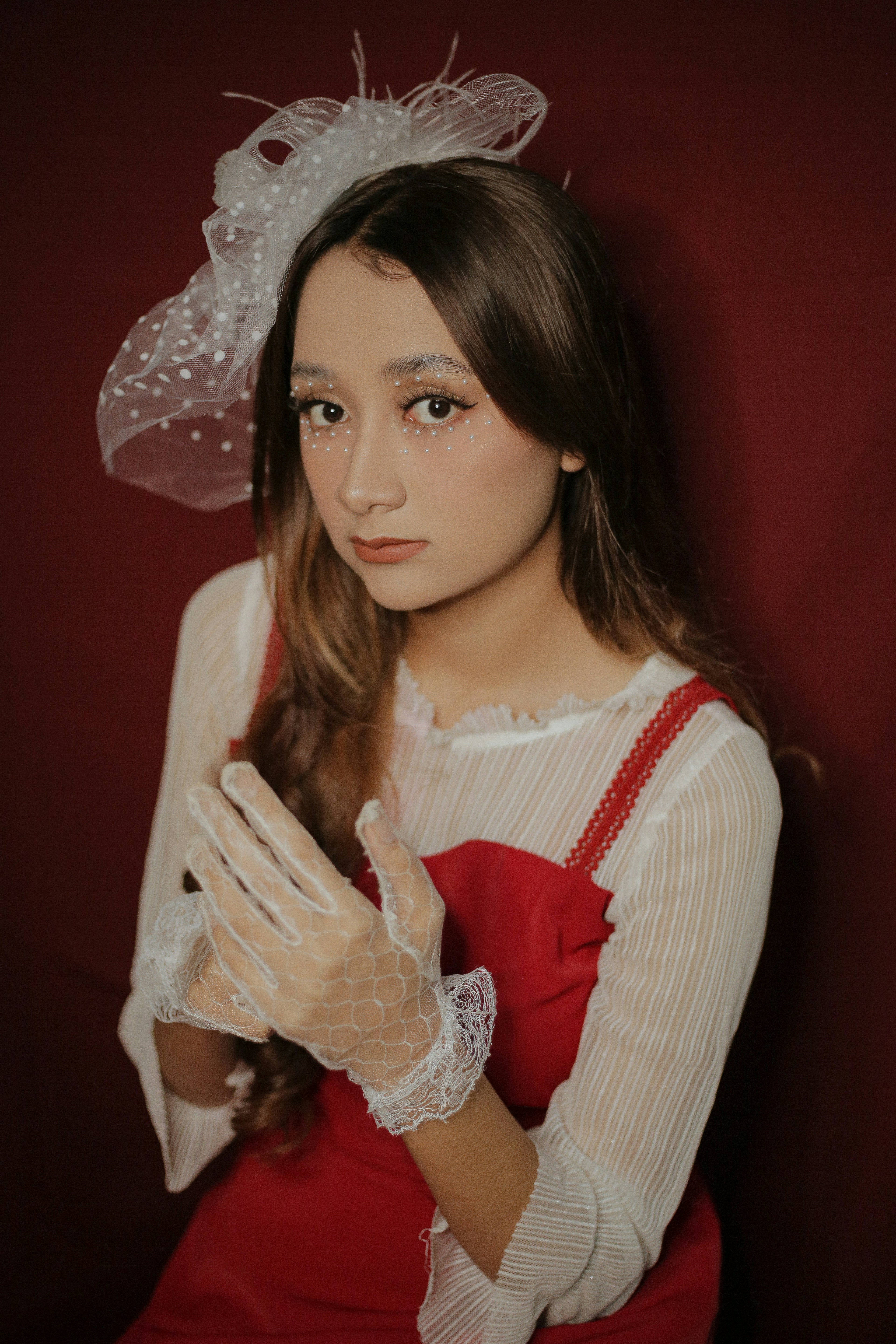 A woman wearing a red dress and white gloves photo – Free Woman Image ...