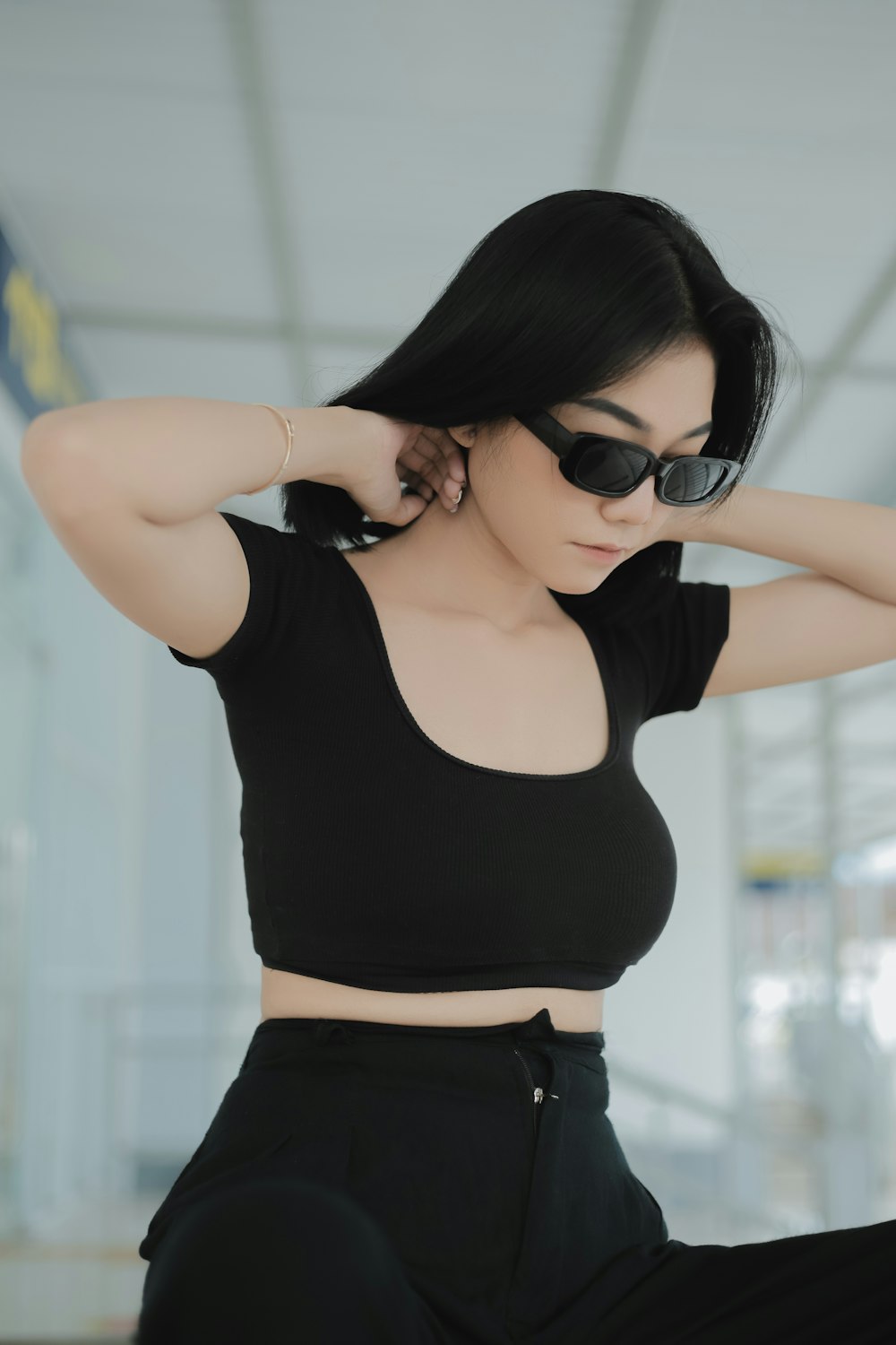 a woman in a black crop top and black pants