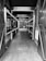 A narrow corridor with signs and posters on the walls, leading to an indoor attraction focused on Irish whiskey. The corridor is adorned with display cases and barrels, and signs with phrases like 'The Authority on Irish Whiskey' and 'Keepers of the True Story.'