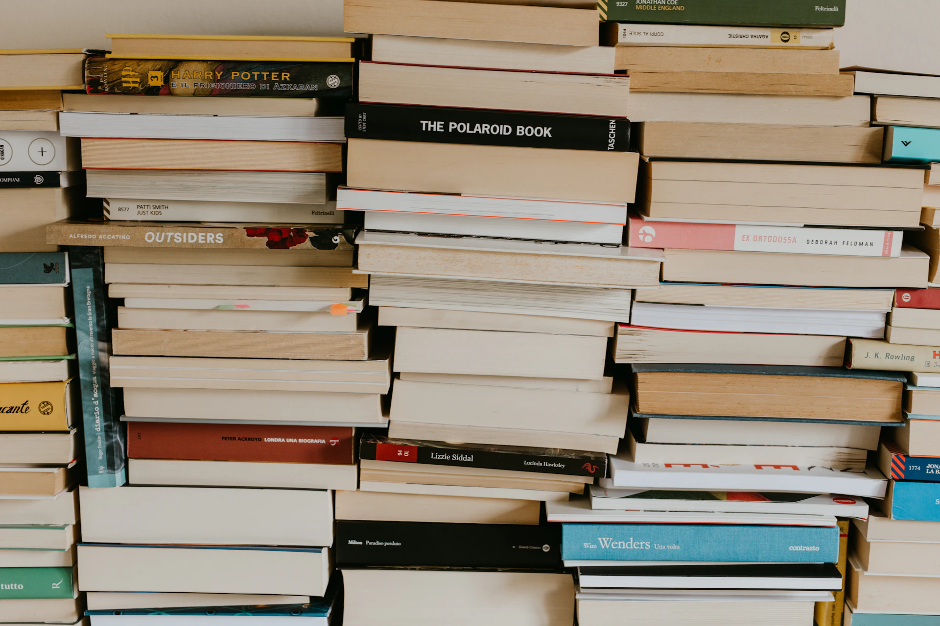 a pile of books sitting on top of a wall