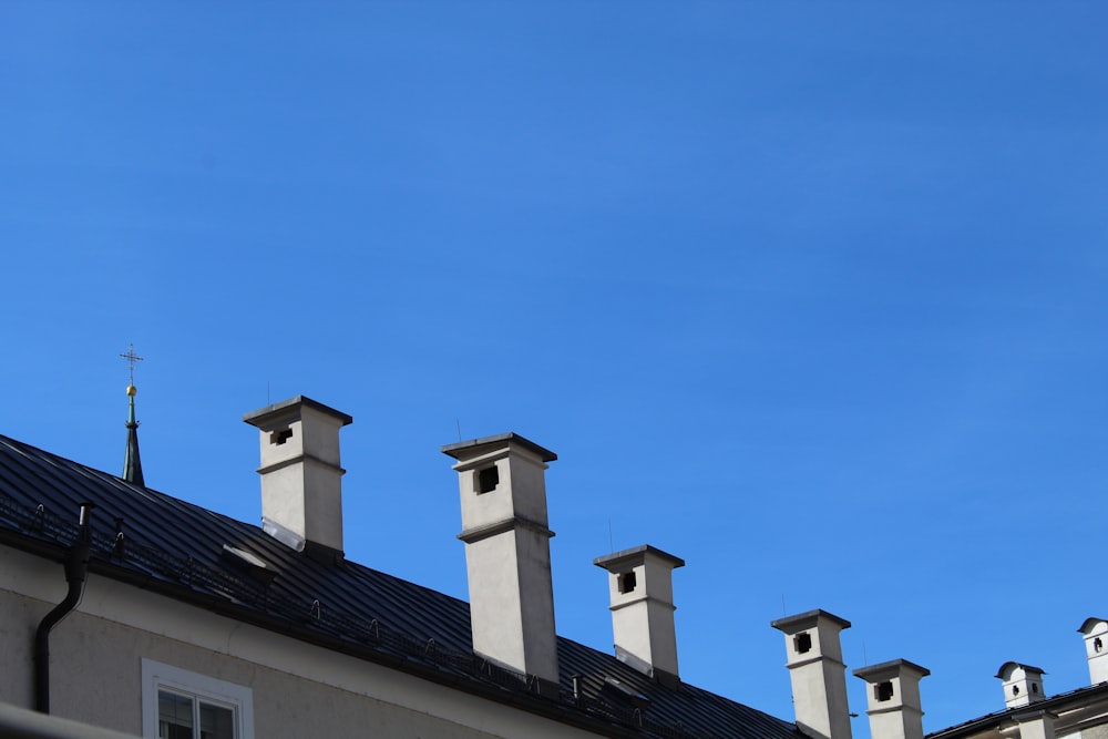 a row of chimneys on top of a building