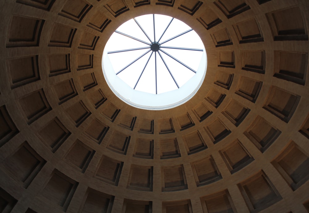 a circular window in a stone structure with a skylight