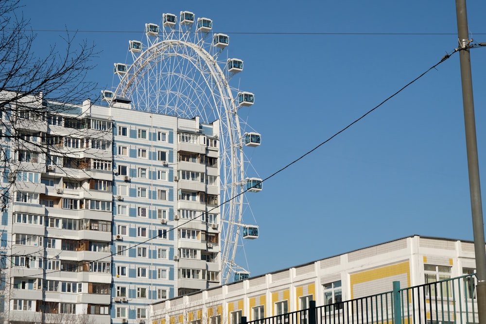 a ferris wheel in front of a tall building