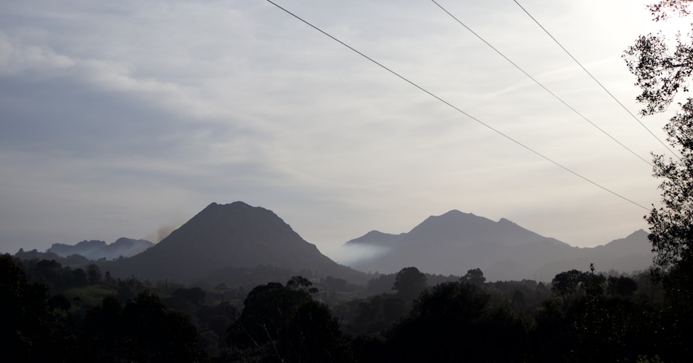 a view of a mountain range with power lines in the foreground