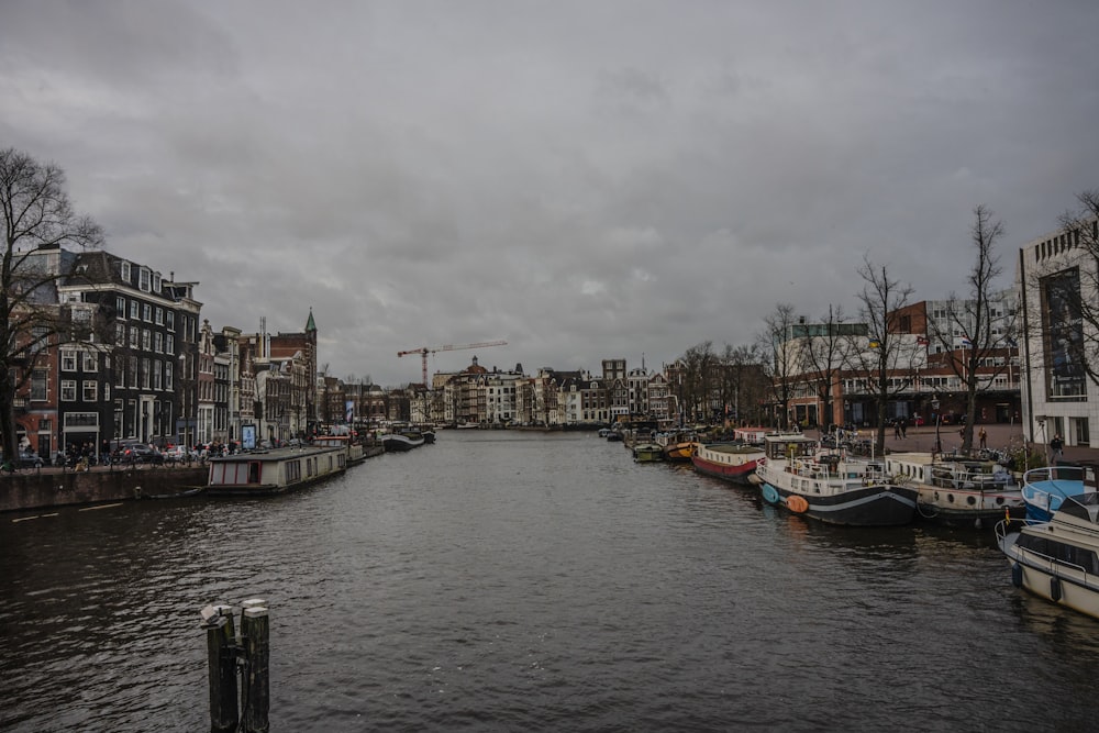 several boats are docked on the river in a city