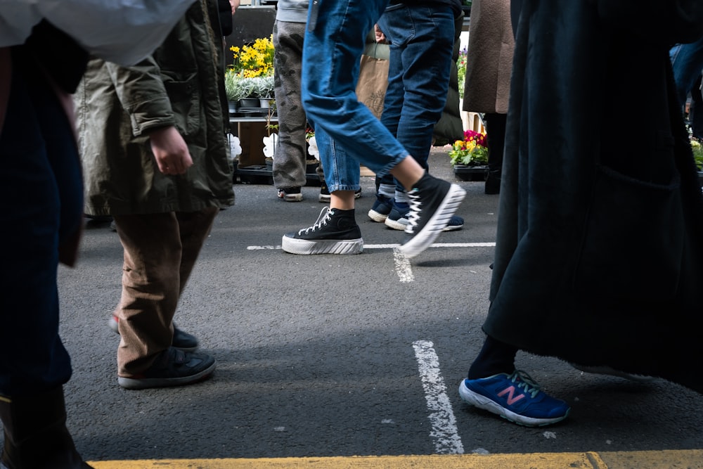 a group of people standing in a parking lot