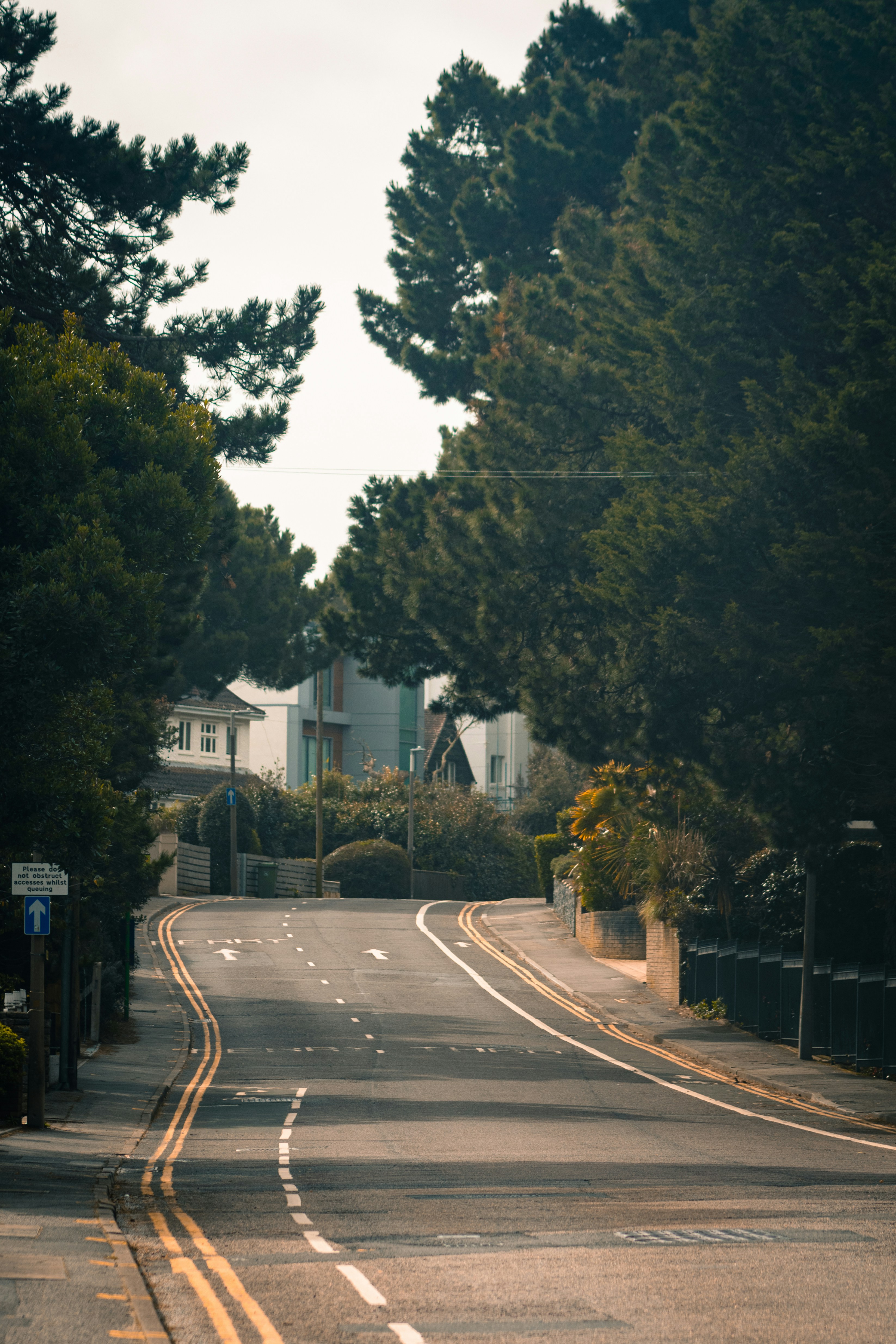 an empty street with a stop sign on the side of it