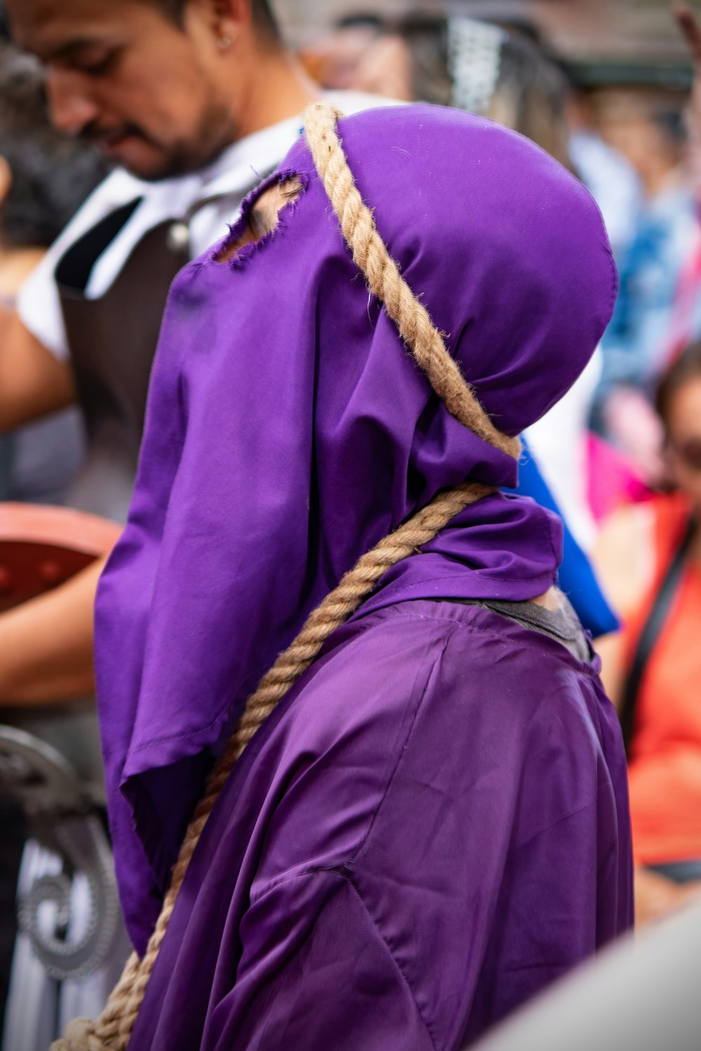 a person wearing a purple outfit and a rope