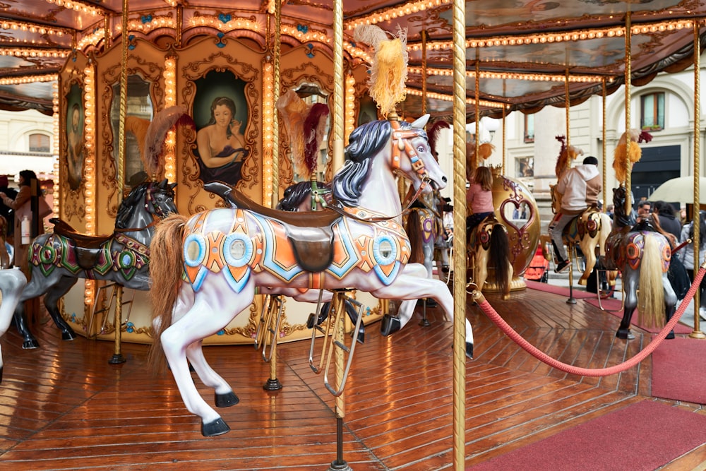 a merry go round with horses on a wooden floor