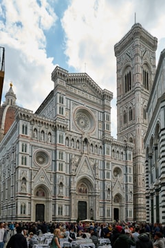 a group of people standing in front of a large building
