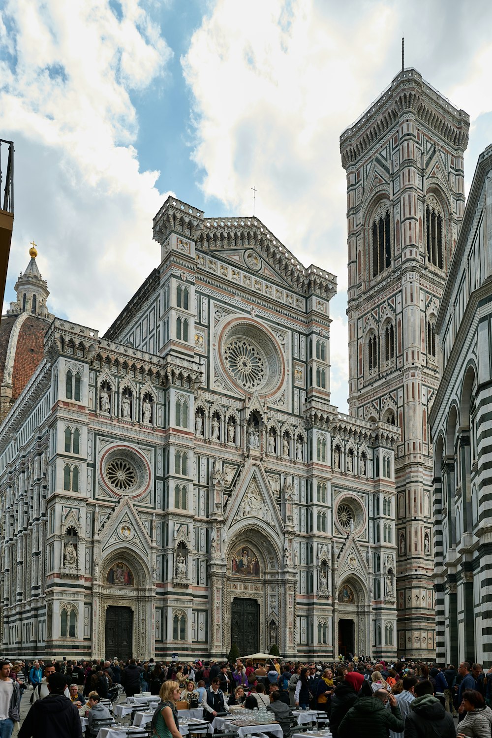 a group of people standing in front of a large building