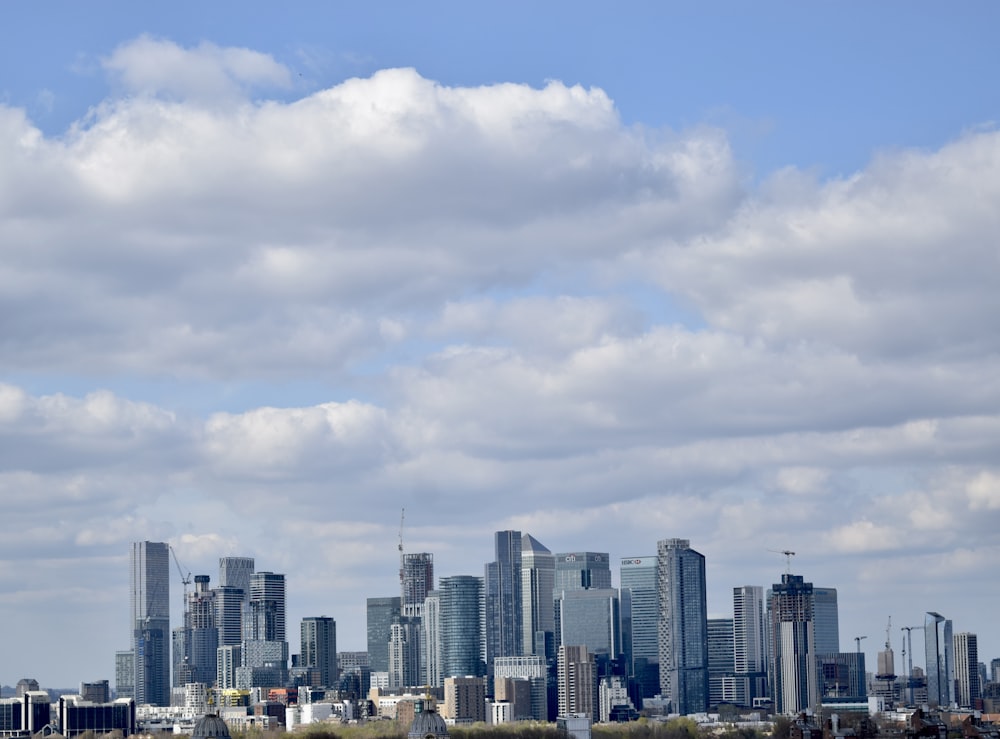 a view of a city with a plane flying in the sky