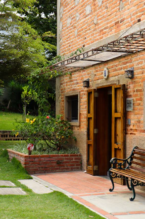 A warm, inviting entrance to the Enon Valley Community Historical Society building surrounded by lush greenery.