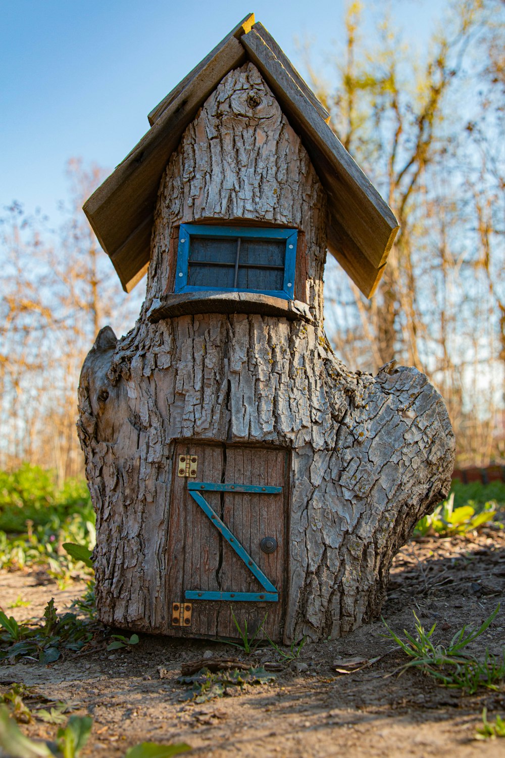 a tree stump with a house built into it