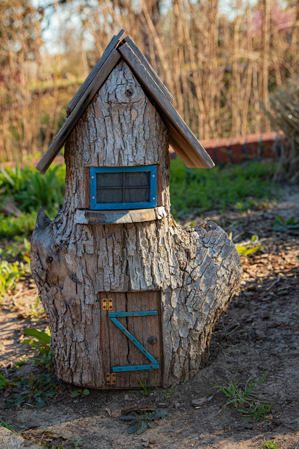 a tree stump with a house built into it