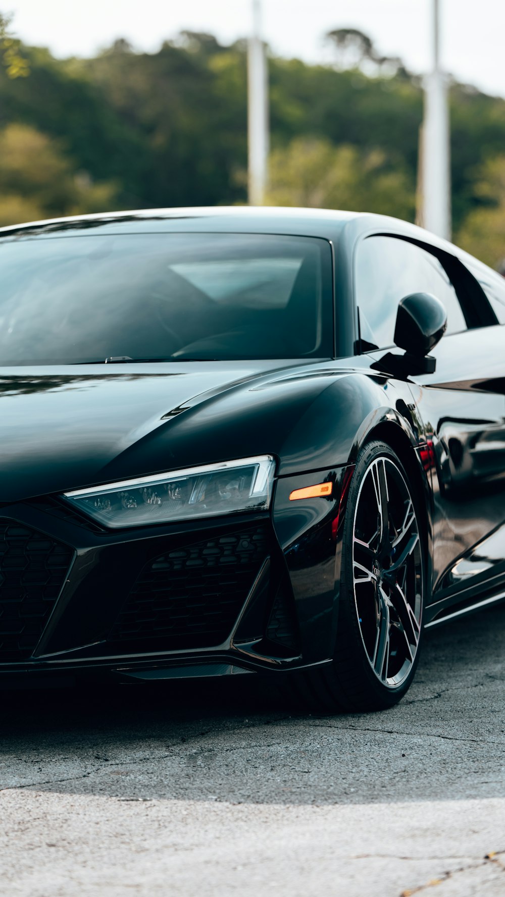 a black sports car parked in a parking lot