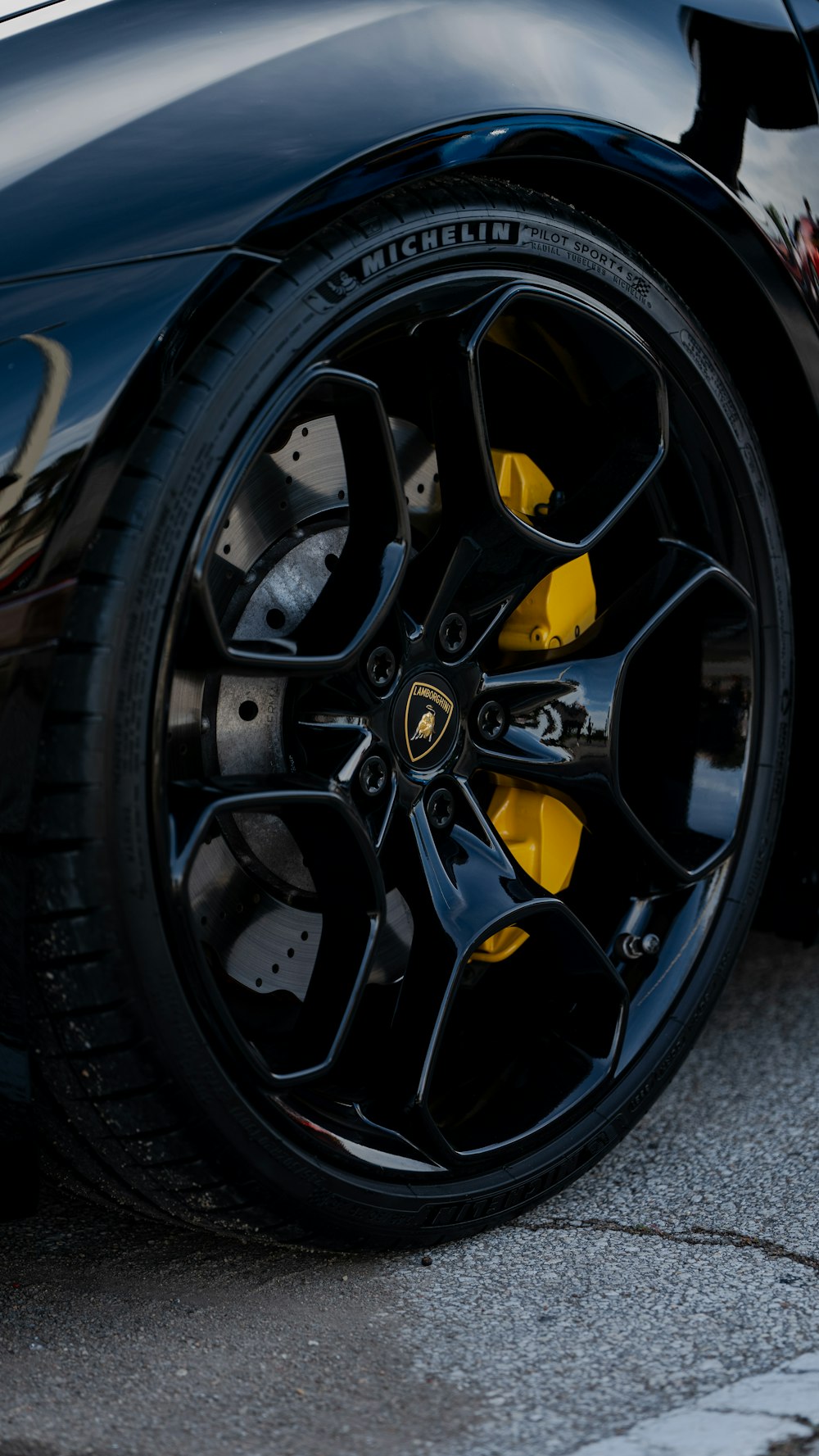 a close up of a black sports car tire