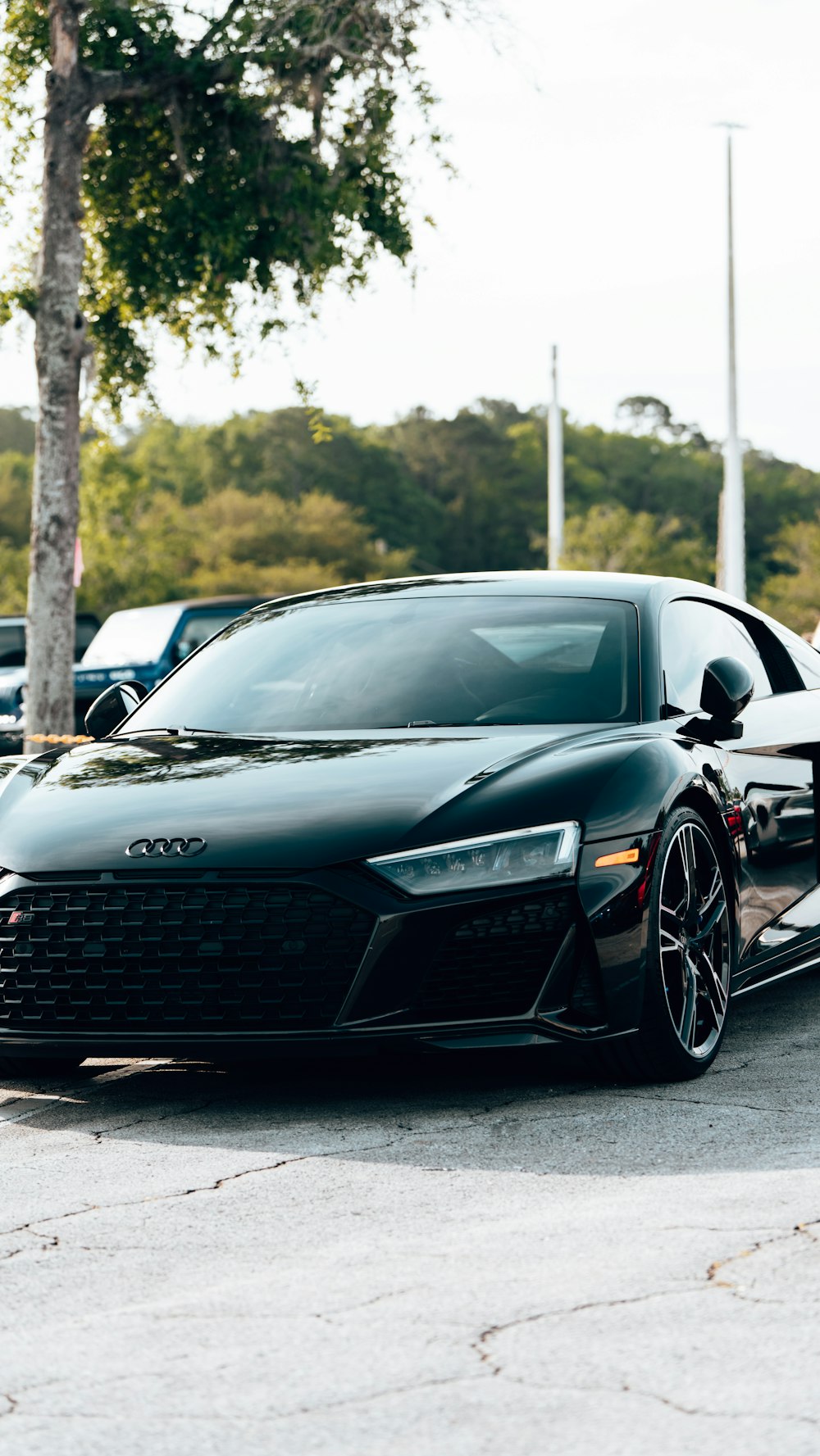 a black sports car parked in a parking lot