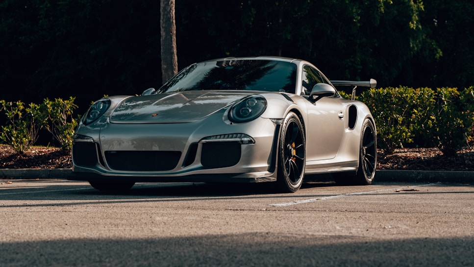 A sleek, shiny Japanese import car parked in a sunlit lot, ready for sale.