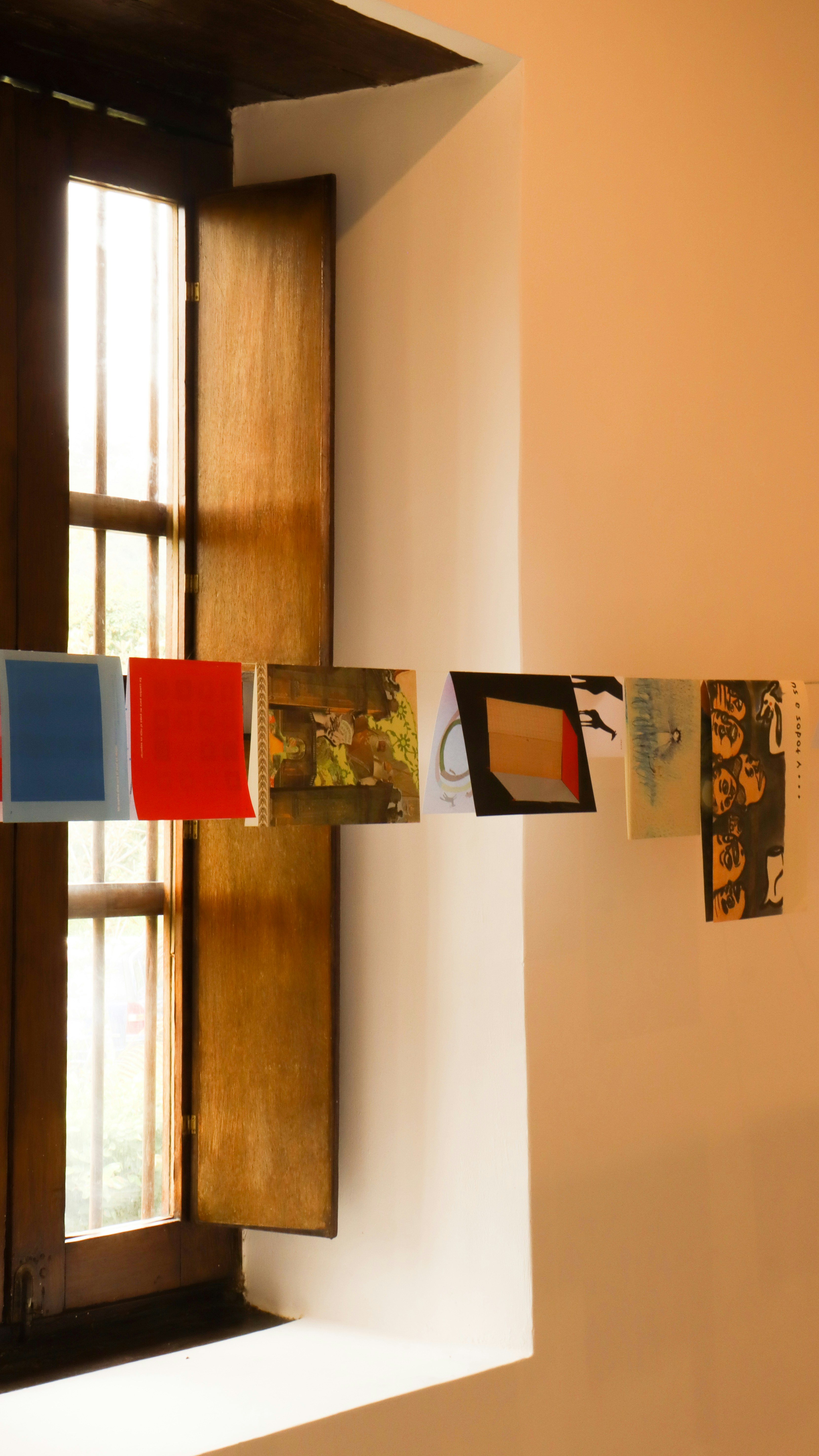 a window with a bunch of pictures hanging on it