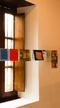 a window with a bunch of pictures hanging on it