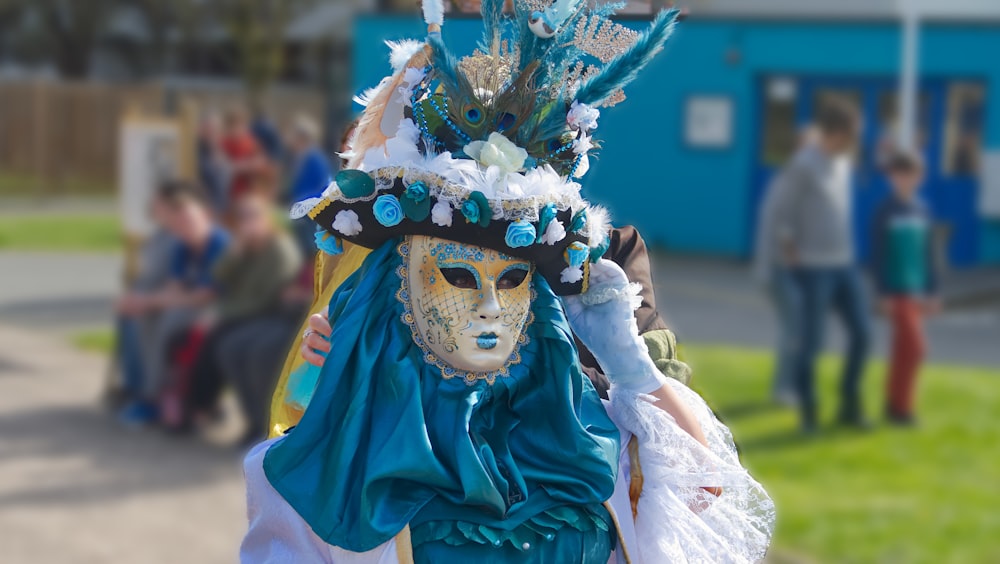 a person wearing a mask and a blue dress