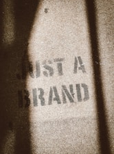 the shadow of a person standing in front of a sign