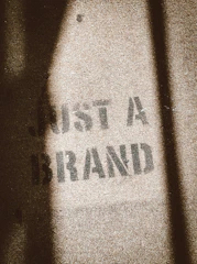 the shadow of a person standing in front of a sign