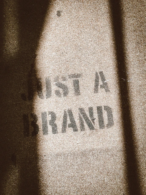 the shadow of a person standing in front of a sign