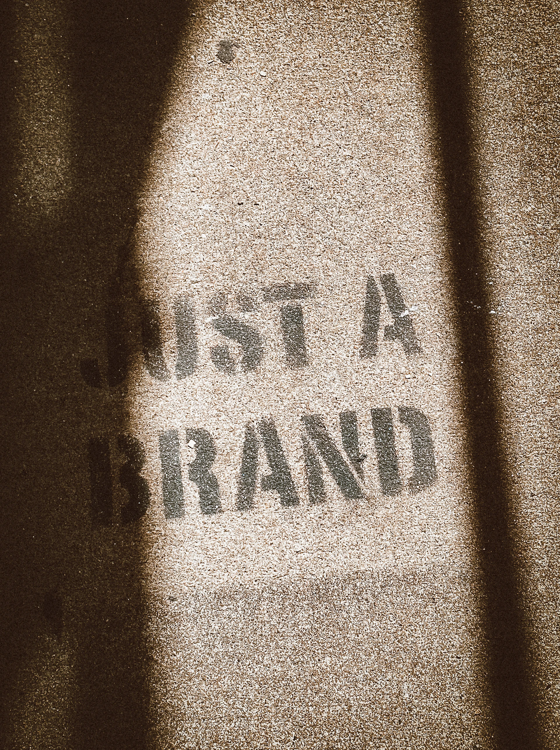 the shadow of a person standing in front of a sign