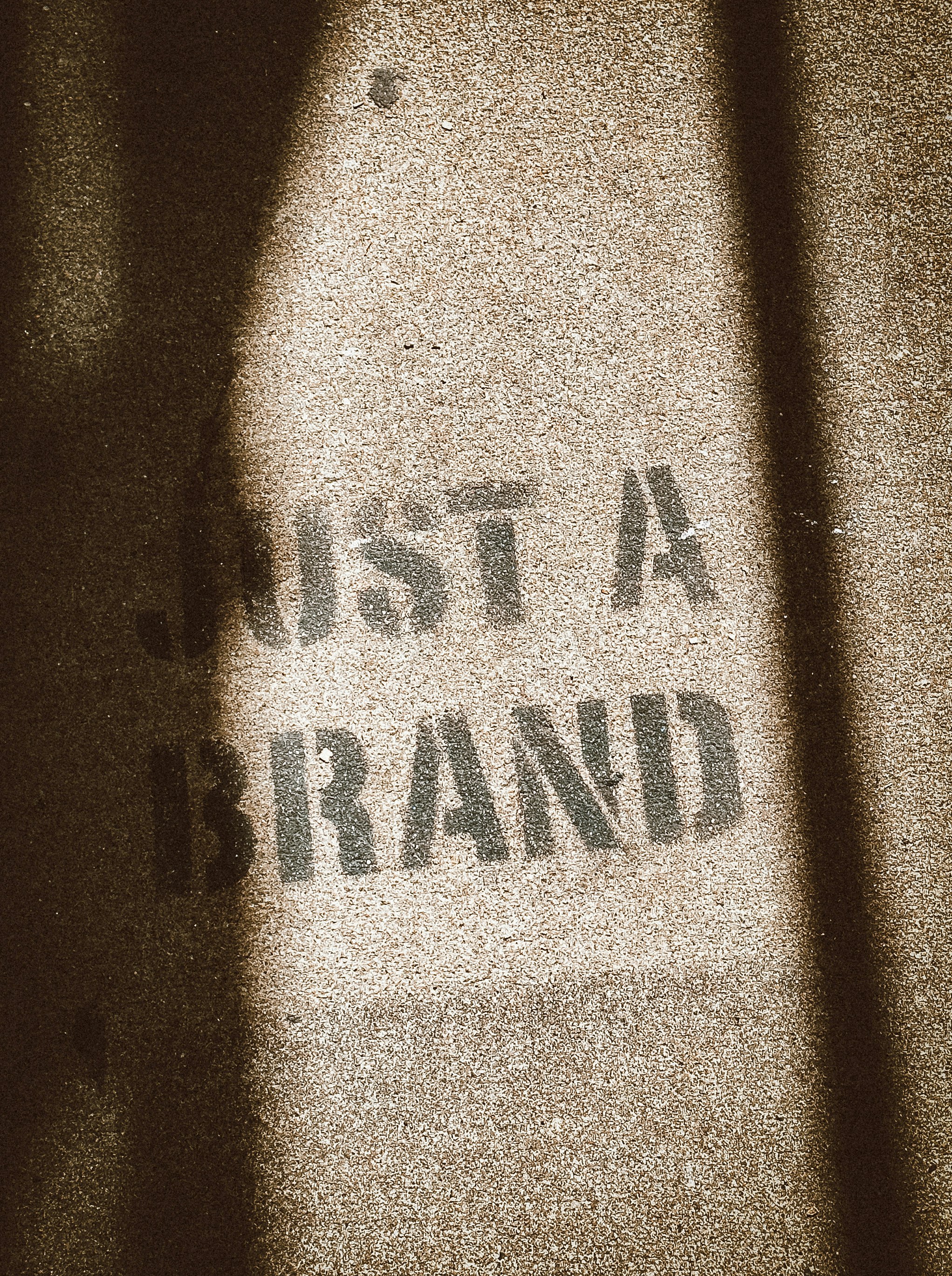 the shadow of a person standing in front of a sign