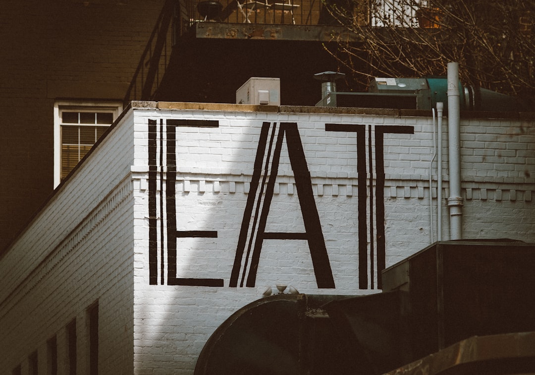 a sign that says eat on the side of a building,