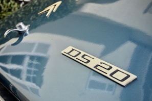 Close-up of a Citroën badge on a car undergoing bodywork restoration