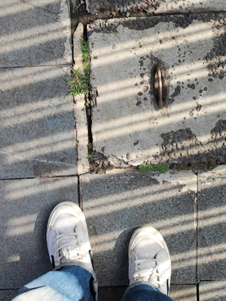 Close-up of a stylish pair of modern sneakers on a concrete sidewalk