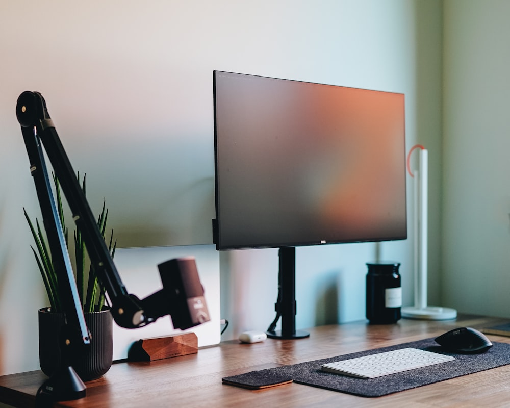 a computer monitor sitting on top of a wooden desk